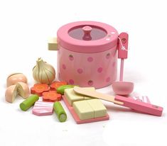 an assortment of kitchen utensils and toys on a white surface