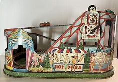 an old toy carnival ride with people on it and other toys in the back ground