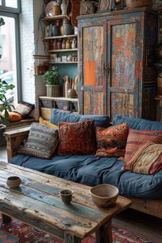 a living room filled with furniture and lots of pillows on top of a wooden table