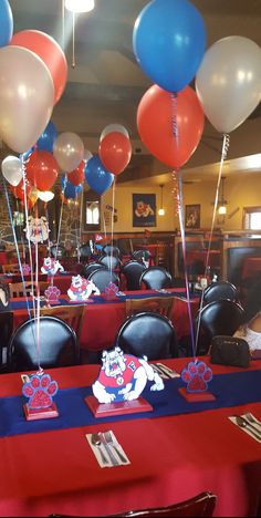 tables with red, white and blue balloons on them