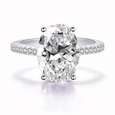 an oval cut diamond ring with pave set shoulders