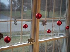 red ornaments hanging from the windows in front of them