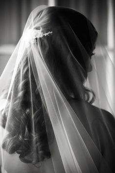 black and white photograph of a woman wearing a veil