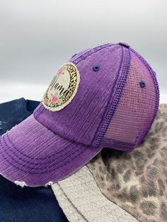 "Distressed trucker hat with featuring a trendy \"Mama\" patch that is securely sewn onto the hat. Hat is available in gray or purple. The hat has a velcro closure in the back allowing the fit to be adjusted. 6 panel hat. Front is made of cotton and back panels are mesh. Because each patch is handmade, there may be slight variations. Also, colors may appear different due to computer monitors. Remember to like our Facebook and Follow us on Instagram (@FabiLovesGracie) for new product updates, cou Purple Trucker Hat With Curved Brim, One Size, Purple Trucker Hat One Size, Purple Trucker Hat With Curved Brim, Purple Curved Brim Trucker Hat, Purple Adjustable Trucker Hat, Casual Purple Adjustable Trucker Hat, Casual Snapback Hat For Birthday, Purple Cap As A Gift, Casual Trucker Hat With Letter Print For Mother's Day