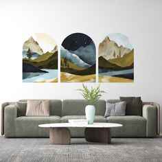 a living room with three paintings on the wall and a coffee table in front of it