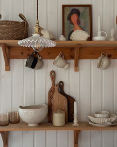 the shelves are filled with dishes and utensils