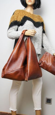 "Genuine Cognac Leather Bag- Asymmetrical Oversize Bag Measurements: 18,5\" wide (bottom) 12\" high 25,5\" total height 14,5\" drop Cosmetic bag 30x20 cm / 12x8\" Brown Asymmetrical Large Bag Oversized Brown Tote Bag -Brown leather asymmetric bag. -Cognac brown cowchide leather. - Inner pocket with zipper - Internal cosmetic bag To return to my shop, simply click here: https://www.etsy.com/shop/BarbaraLeatherDesign Shipping: * Europe 2-7 days * USA 5-10 days * Other countries 7-14 days" Large Hobo Bag For Shopping, Cognac Leather Bag, Oversized Shoulder Bag, Simple Leather Bag, Black Rucksack, Brown Tote Bag, Large Handbag, Soft Leather Bag, Oversized Bag