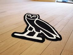 a black and white owl rug sitting on top of a hard wood floor