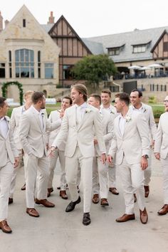 a group of men in white suits and ties