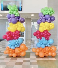 there are many balloons in the air on this floor and one is multicolored