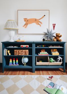 a child's playroom with toys and books on the shelves in front of it