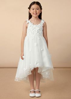 Your flower girl will look pretty like a princess in Ceres, our floral tulle Ball-Gown dress. She features a lace bodice and straps adorned with 3D flowers, a frilly tulle high-low skirt, and a beautiful matte satin bow at the back. Sleeveless Tulle First Communion Dress With Floral Applique, Sleeveless Tulle Dress With Floral Applique For First Communion, Tulle First Communion Dress With Floral Applique, Sleeveless Tulle Gown For Confirmation, Spring Confirmation Gown Made Of Tulle, Spring Confirmation Gown In Tulle, Spring Tulle Gown For Confirmation, Ivory Ball Gown, White Ball Gowns