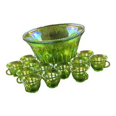 a green glass bowl and six glasses on a white background with the image in full color