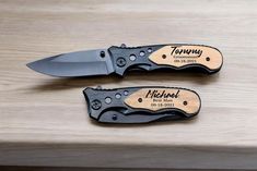 two knives sitting on top of a wooden table next to each other with the name tommy engraved on them