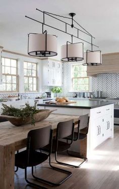 a kitchen with an island, table and chairs