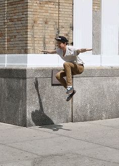 a man flying through the air while riding a skateboard