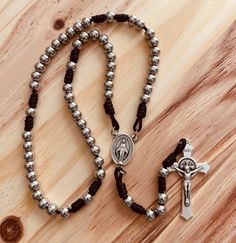 "Paracord Rosary Stainless steel beads 8mm St. Benedict Crucifix measures 2 1/4\" Miraculous medal centerpiece measures 1\" Black Paracord 95 Split double jump rings  include burlap bag We ship within one business day! Thanks for Visiting" Paracord Rosary, St Benedict, Miraculous Medal, Jump Rings, Paracord, Selling On Etsy, Burlap Bag, Sell On Etsy