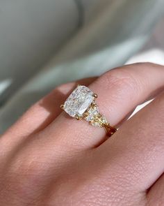 a woman's hand with a diamond ring on it