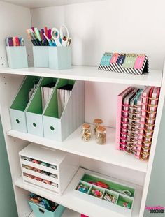 a white shelf filled with lots of craft supplies and storage bins on top of it