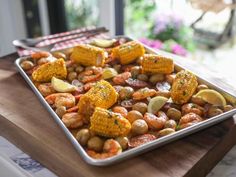 a tray filled with shrimp and corn on the cob