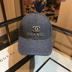 a blue hat with the word chanel on it sitting on top of a table