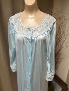 If you love anything in a soft aqua blue color you might fall in love with this pretty robe.   No indication it was ever worn.   Lightweight nylon is comfy and easy to wear.   Popular Gilead lingerie that you might have in your collection already. A  wide dyed to match lace section about the bust and on the 3/4 sleeves.  A bit of fullness in the sleeves. Buttons down the front. Single seam pocket. Nice fullness front and back. Wash in a mesh lingerie bag cool delicate cycle and hang to dry.  Onl Blue Long Sleeve Sleep Robe, Long Sleeve Blue Nightgown For Home, Blue Long Sleeve Robe For Sleep, Blue Nightgown For Spring, Blue Spring Nightgown For Overnight, Light Blue Long Sleeve Nightgown For Spring, Elegant Light Blue Sleepwear For Loungewear, Blue Long Sleeve Robe, Light Blue Long Sleeve Nightgown For Bedtime