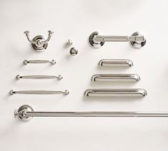 an assortment of bathroom hardware on a white surface