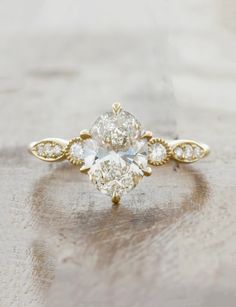 an oval diamond ring with three pear shaped diamonds