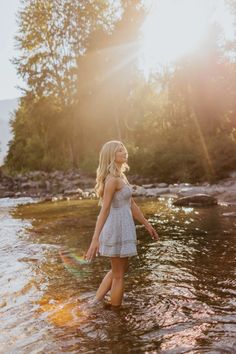 a woman standing in the middle of a river