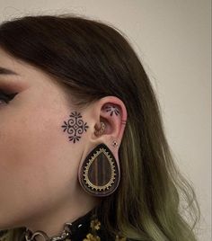 a woman with some piercings on her ear