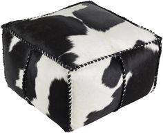 a black and white cow print square ottoman