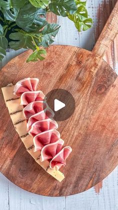 a wooden cutting board topped with slices of meat