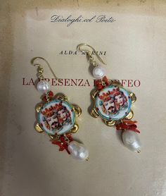 ✔️Beautiful handmade Sicilian earrings! Composed of Sicilian tambourine in Caltagirone ceramic, hand painted, depicting the typical Sicilian Moorish Heads. Baroque pearl and hanging coral chips. Customizable, on request, with the mounting of nuns or different pins. Wear the tradition of beautiful Sicily and always carry it with you with this unique jewel! Suitable to enrich a casual outfit or for an important moment! ✔️DETAILS: 🟩 Materials: Caltagirone ceramics Baroque pearl Coral 🟧🟧 Dimensio