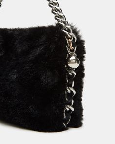 Introducing the FUZZ bag - the ultimate combination of fashion and functionality. Featuring a cozy fuzzy exterior, a chain shoulder strap, and a secure magnetic snap closure, this bag is both stylish and practical. Elevate your look with this must-have accessory. Fuzzy shoulder bag Chain strap Mag snap closure Shoulder strap: 12 inches 5.5in H x 9.5in W x 1in D Synthetic materials Duster bag included Imported Chic Evening Shoulder Bag With Faux Fur Lining, Chic Fluffy Shoulder Bag For Everyday, Shoulder Strap Bag, Strap Bag, Bag Chain, Synthetic Materials, Chain Strap, Snap Closure, Shoulder Strap