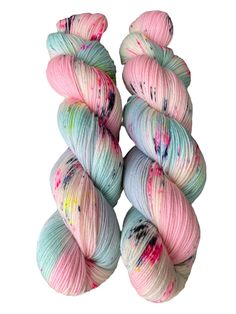 three skeins of yarn with paint splattered on the top and bottom