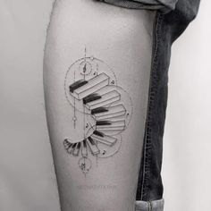 a black and white photo of a person's leg with a tattoo on it