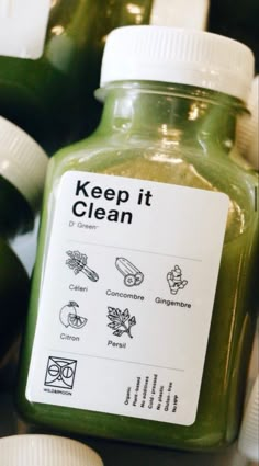 a bottle of green juice with labels on it