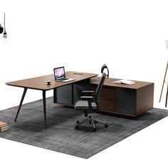 an office desk with a laptop computer on it