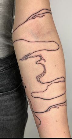 a woman with a tattoo on her arm that is shaped like an abstract line drawing