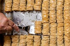 a person using a pair of scissors to cut pastries on a sheet of tin foil