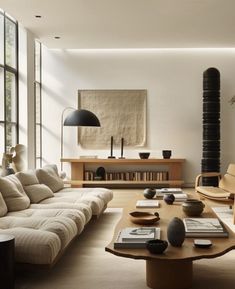 a living room filled with lots of furniture and a tall lamp in the middle of it