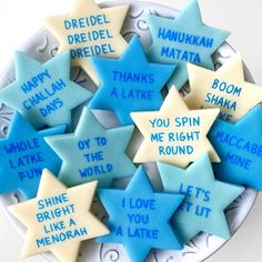 blue and white cookies with words written on them in the shape of star shaped stars