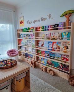 a child's playroom with bookshelves and toys