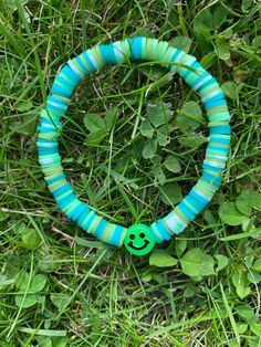 Colourful bracelet in shades of green with a smiley face Trendy Green Bracelet Jewelry, Trendy Green Bracelets As A Gift, Trendy Green Bracelet As Gift, Trendy Green Bracelet For Gift, Fun Green Beaded Bracelets With Round Beads, Trendy Green Bracelets For Friendship, Trendy Green Beaded Bracelets For Friendship, Casual Green Round Jewelry, Green Beaded Bracelets For Friendship