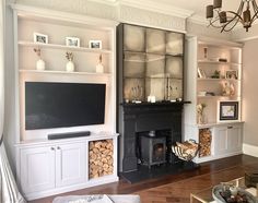 a living room filled with furniture and a fire place in front of a tv mounted on a wall