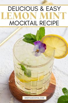 a glass with lemon and mint mojita recipe on the side next to a wooden board