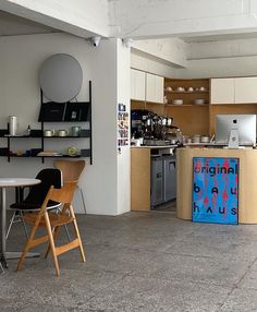 an empty kitchen and dining area with chairs