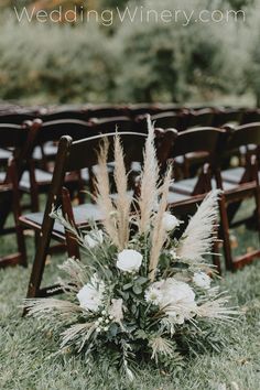 an outdoor ceremony with chairs and flowers