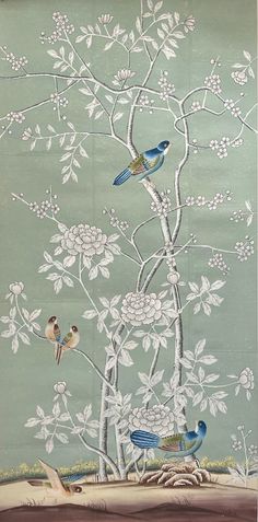 two birds sitting on top of a tree with white flowers in the branches and leaves