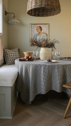 a table with a black and white checkered cloth on it next to a window